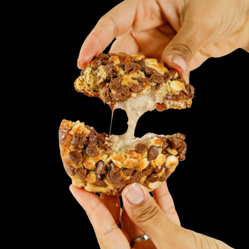"Stack of golden brown Air Fryer Chocolate Chip Cookies with melted chocolate chips on a cooling rack."